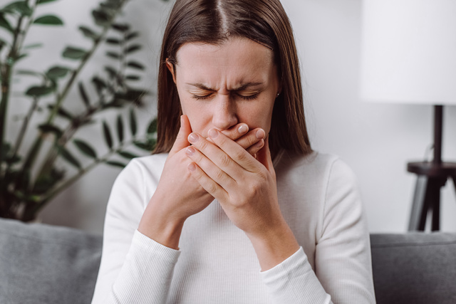 Person struggling with fear of vomiting and nausea anxiety